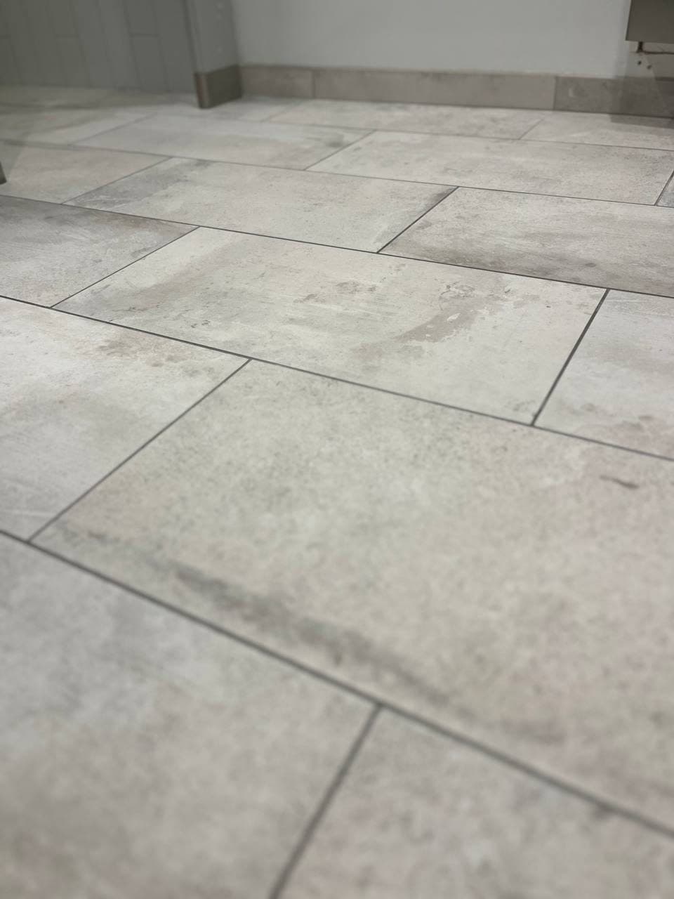 Large-format stone-look porcelain floor tile in a one-third offset