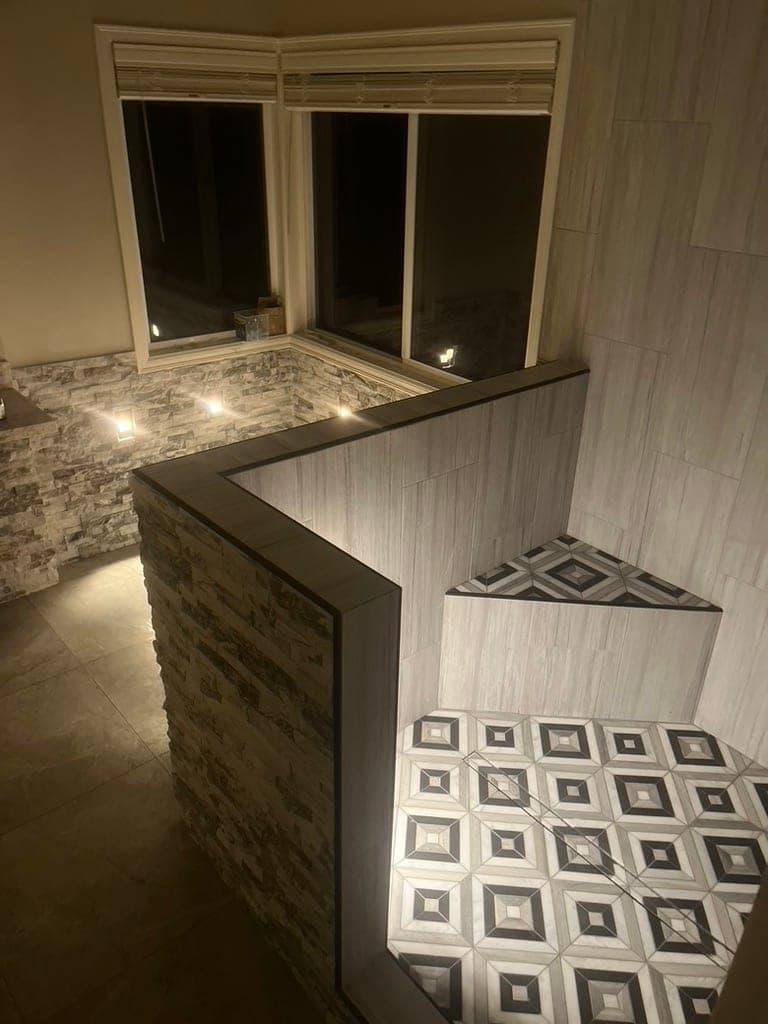 Shower with Geometric Floor and Lit Mosaic Niches