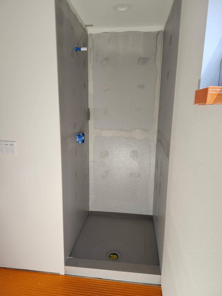 Shower framed in foam waterproofing board with the pan and valve in place