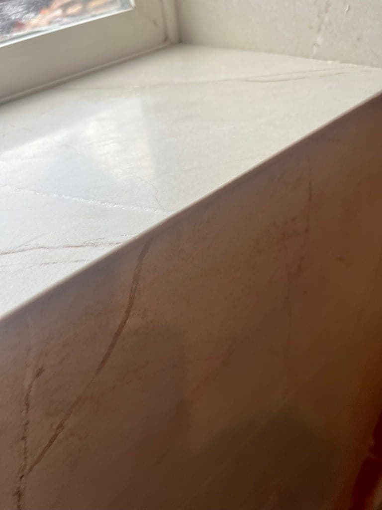 Close-up of a mitered outside corner in marble-look porcelain slab