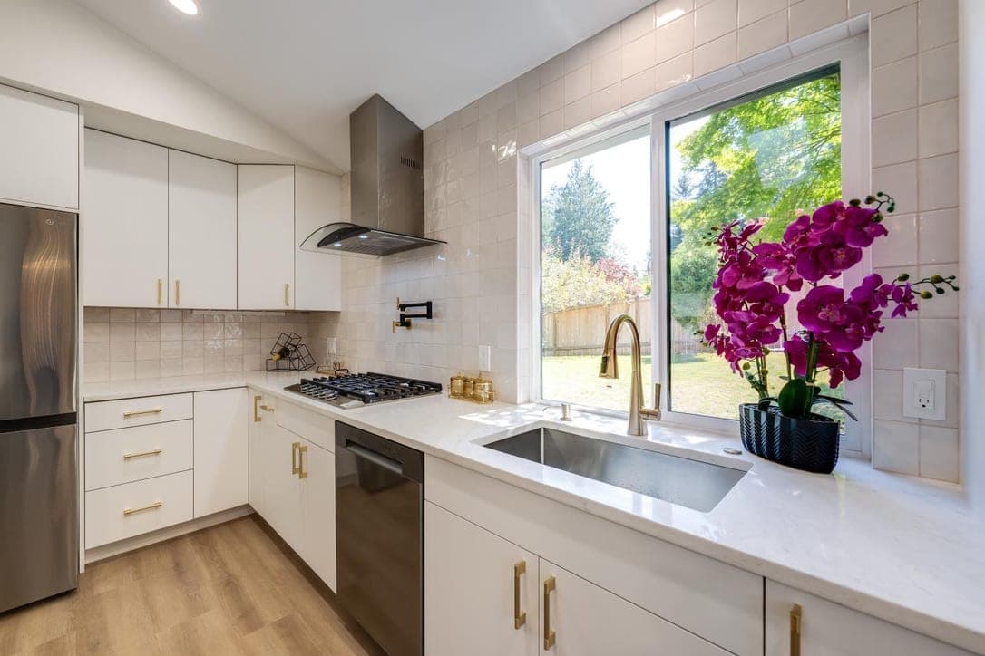 Square tile backsplash wrapping around the kitchen window above the sink